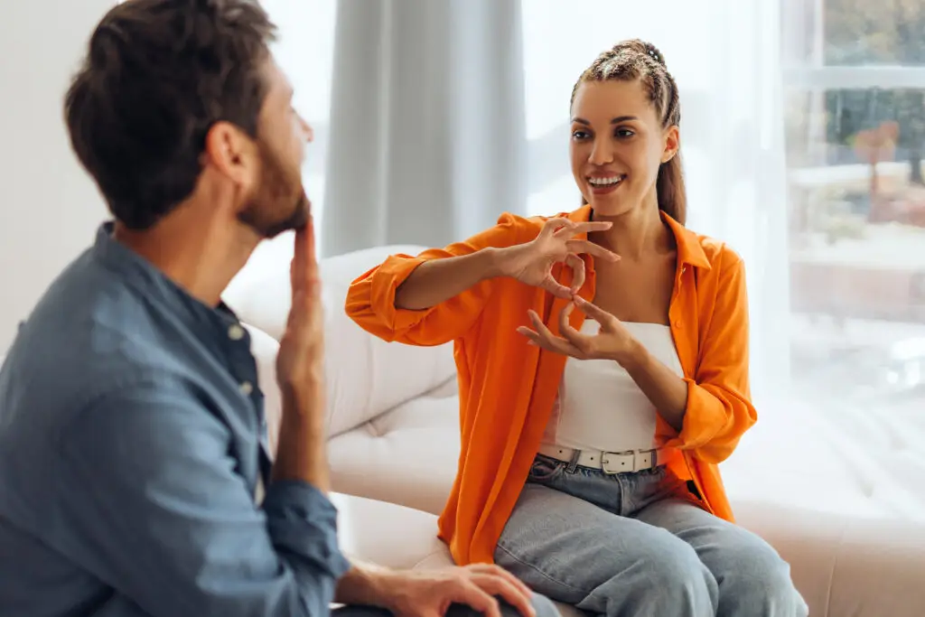 Run as One: Cross-Functional Collaboration 2 MigiHub interpreter sign language management software a man and woman sitting on a couch
